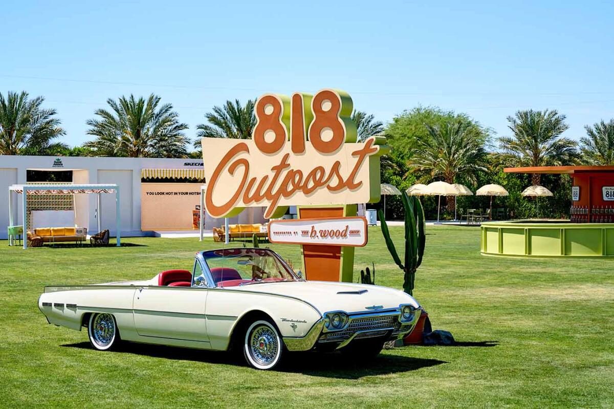 The 818 Outpost sign and a vintage white convertible on the grass at the Coachella Valley activation